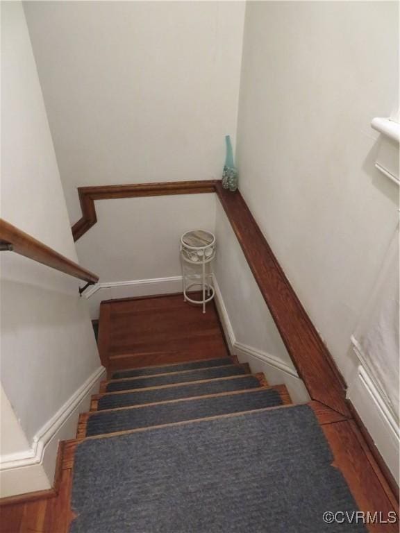 staircase with hardwood / wood-style floors