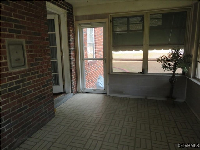 unfurnished sunroom with electric panel