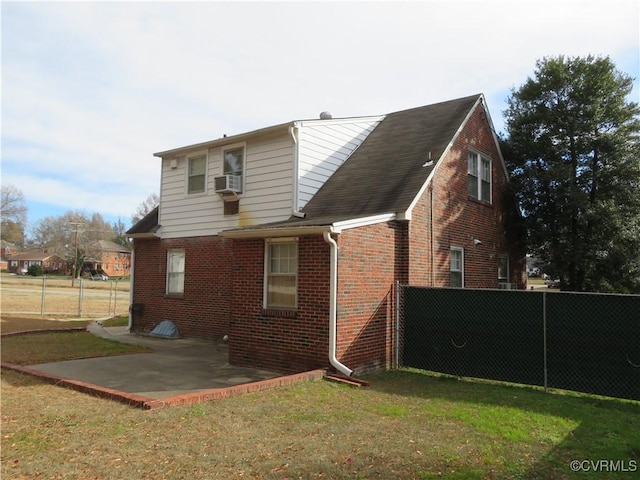 back of property with a patio, cooling unit, and a lawn