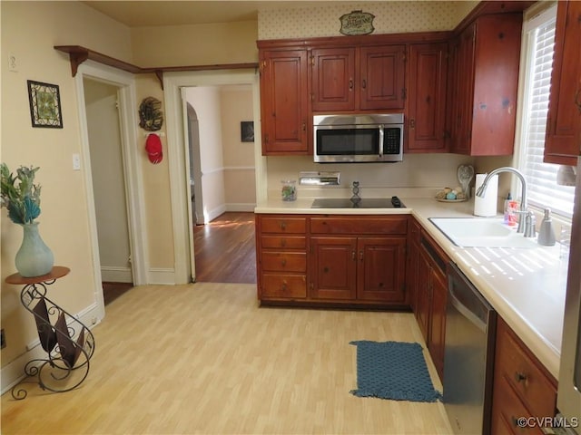 kitchen featuring light hardwood / wood-style flooring, stainless steel appliances, and sink