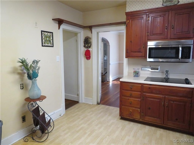 kitchen featuring black electric stovetop and light hardwood / wood-style floors