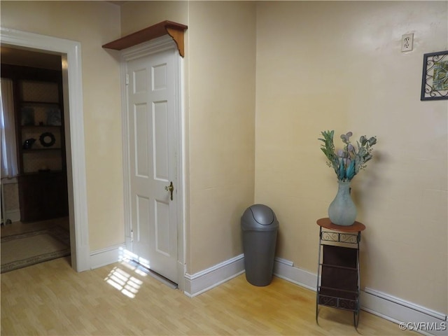 hallway with light hardwood / wood-style flooring