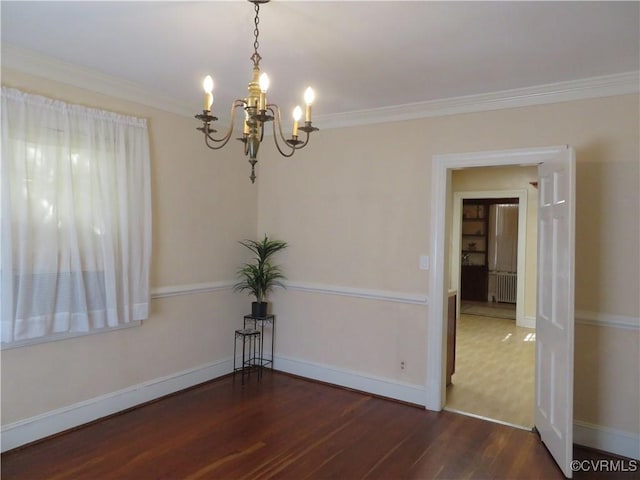 unfurnished room with radiator, crown molding, dark wood-type flooring, and an inviting chandelier