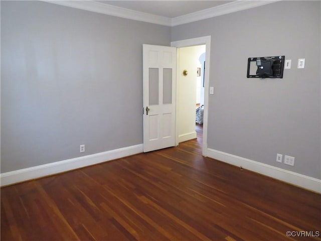 unfurnished room featuring crown molding and dark wood-type flooring