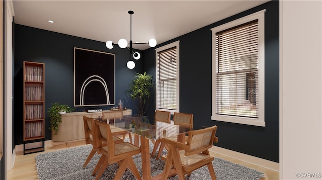 dining space featuring a chandelier and light wood-type flooring