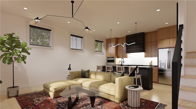 living room with sink and light hardwood / wood-style floors