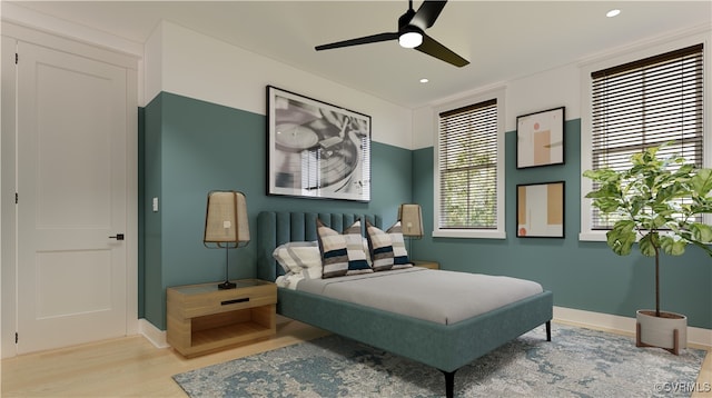 bedroom with ceiling fan, light wood-type flooring, and multiple windows