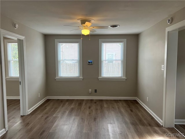 empty room featuring ceiling fan and dark wood-type flooring