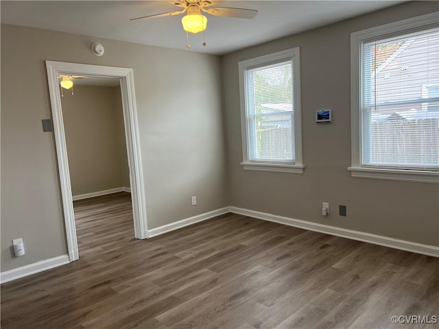 empty room featuring dark hardwood / wood-style floors and ceiling fan