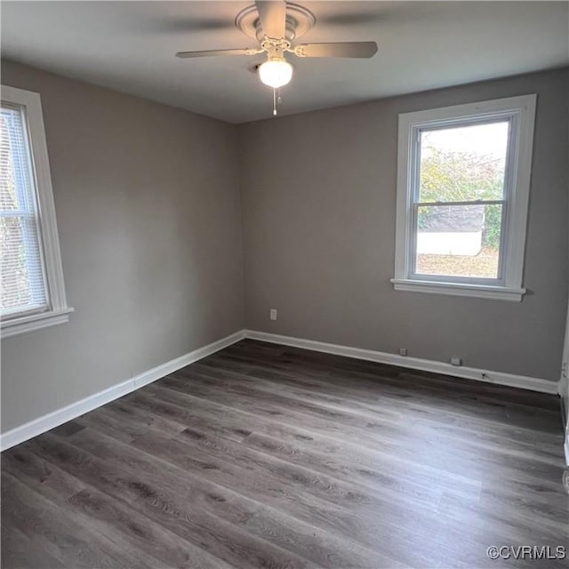 spare room featuring dark hardwood / wood-style floors and ceiling fan