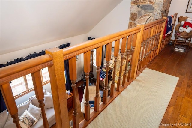 stairs with hardwood / wood-style flooring and vaulted ceiling