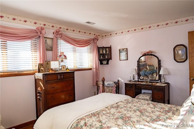 bedroom with multiple windows