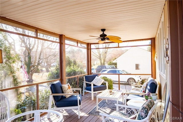 sunroom / solarium featuring ceiling fan