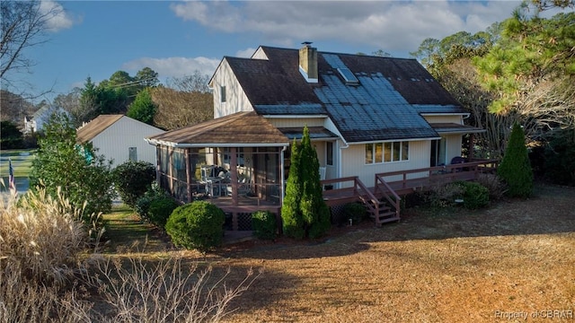 rear view of house with a sunroom and a deck