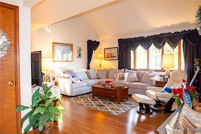 living room featuring hardwood / wood-style floors and vaulted ceiling