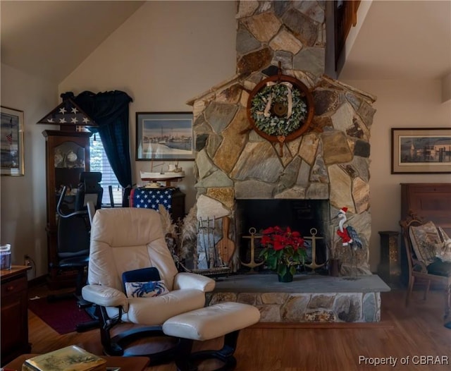 living room featuring a fireplace, hardwood / wood-style flooring, and lofted ceiling