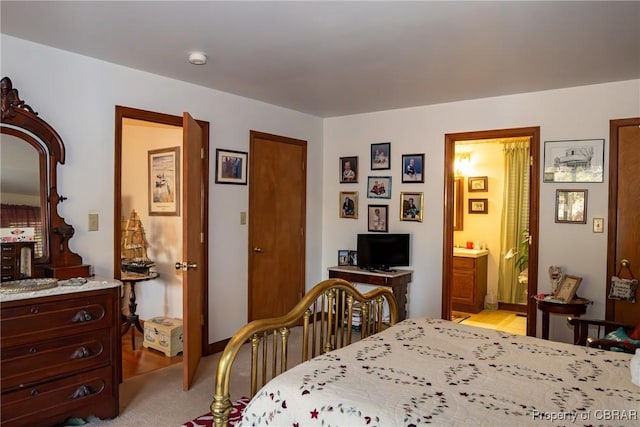 carpeted bedroom with ensuite bathroom