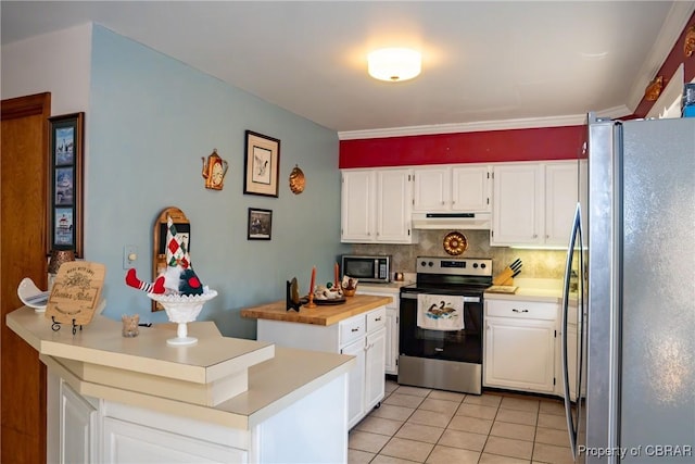 kitchen featuring backsplash, white cabinets, light tile patterned flooring, and appliances with stainless steel finishes