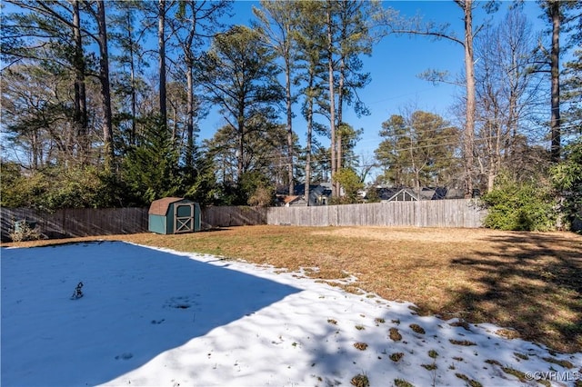 yard layered in snow with a shed