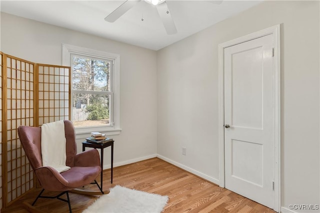 sitting room with ceiling fan and light hardwood / wood-style flooring