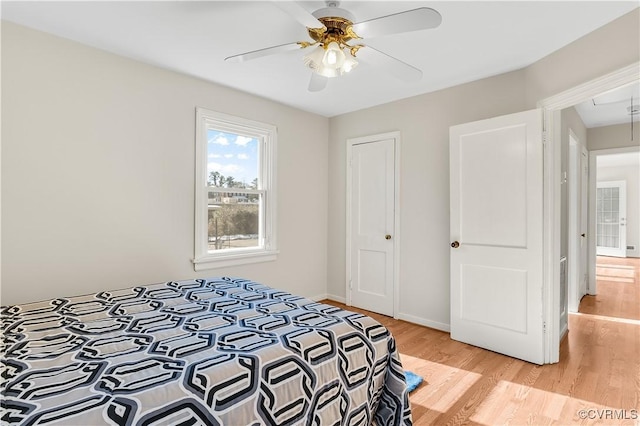 bedroom with ceiling fan and light wood-type flooring