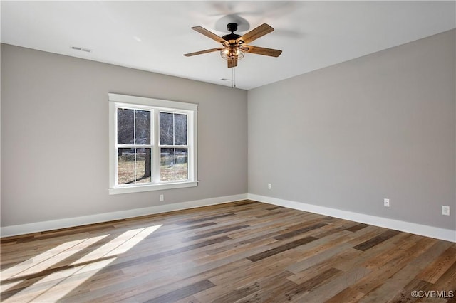 unfurnished room with ceiling fan and wood-type flooring