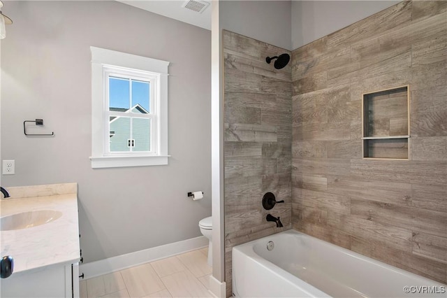 full bathroom featuring toilet, tile patterned flooring, tiled shower / bath, and vanity