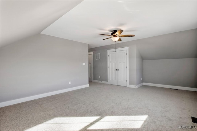 additional living space featuring vaulted ceiling, ceiling fan, and light carpet