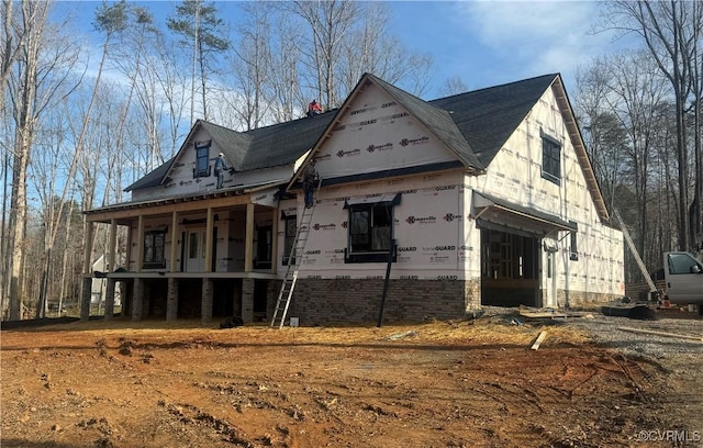 view of side of home with a porch