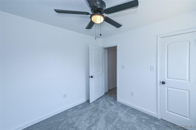 unfurnished bedroom with ceiling fan and light colored carpet