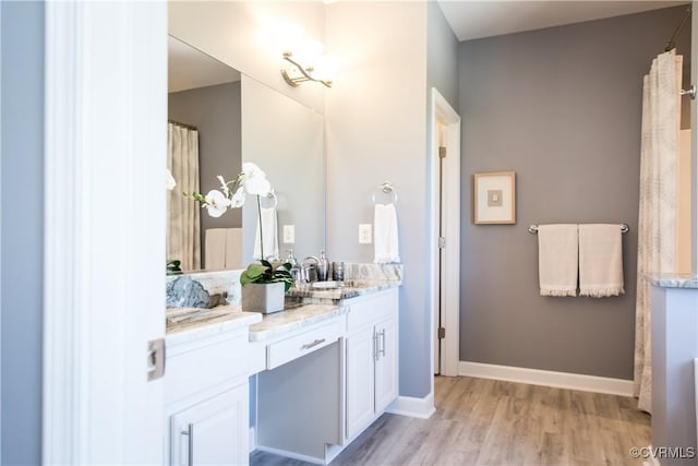 bathroom with vanity and hardwood / wood-style flooring