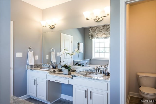 bathroom with hardwood / wood-style floors, vanity, and toilet