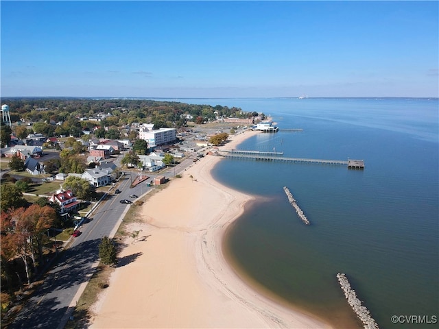 bird's eye view featuring a water view and a beach view