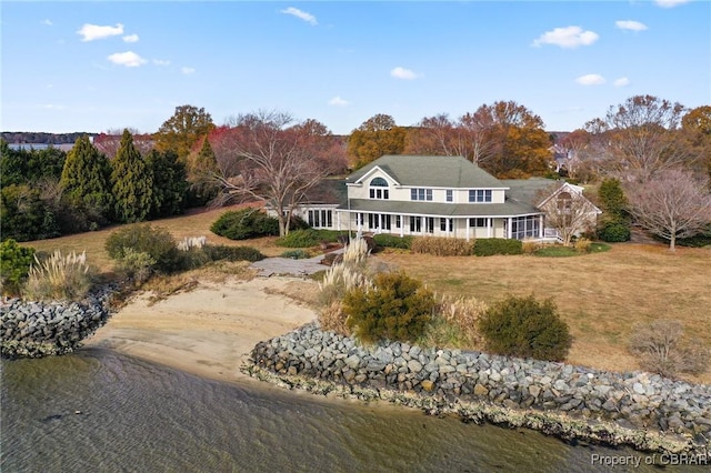 back of property with a water view