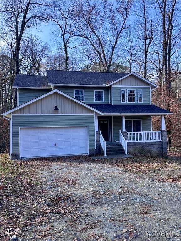 front of property with covered porch and a garage