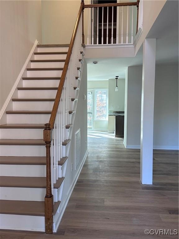 stairway featuring wood-type flooring