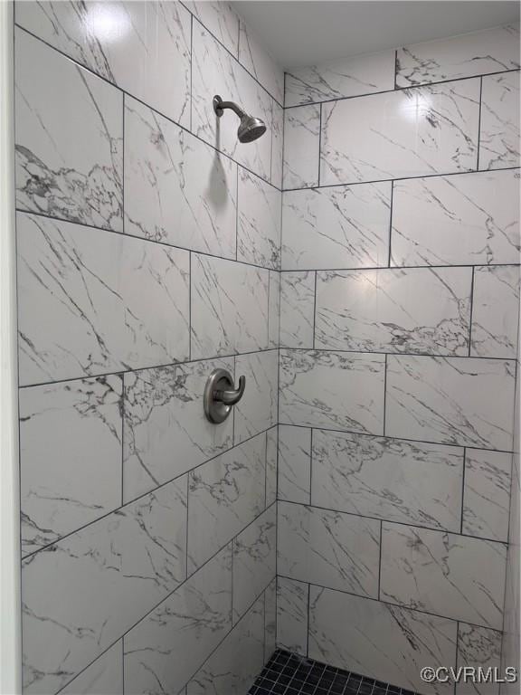 bathroom with a tile shower