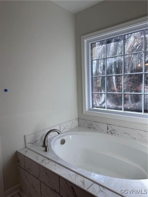 bathroom featuring a relaxing tiled tub