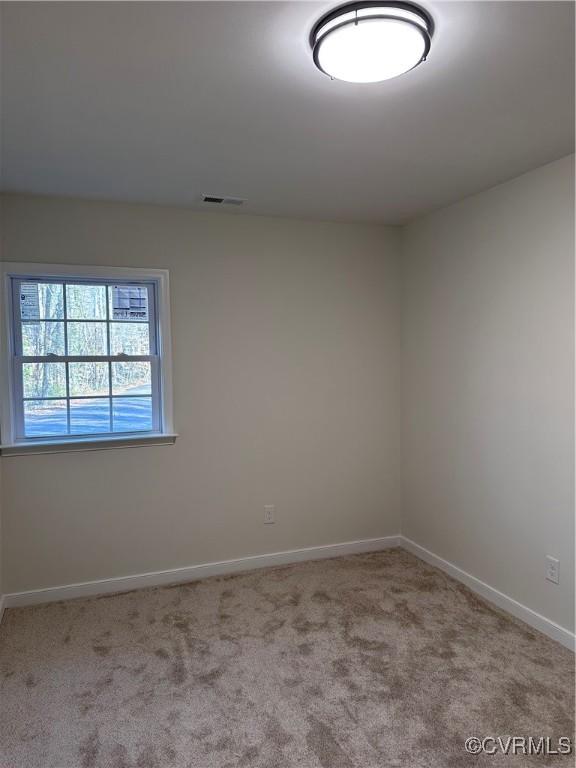 spare room with light colored carpet