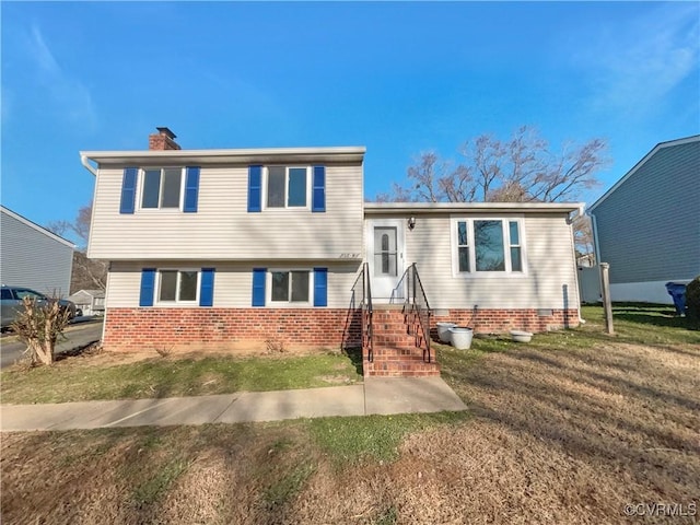 tri-level home with a front lawn