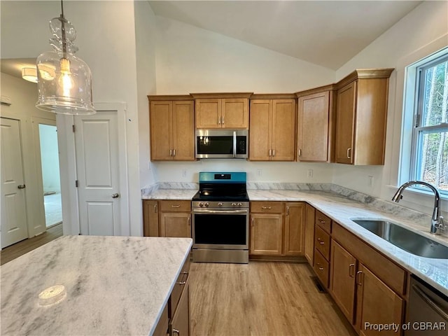 kitchen with a sink, brown cabinets, and appliances with stainless steel finishes