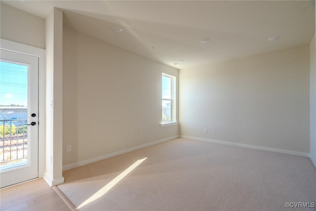 unfurnished room with light carpet