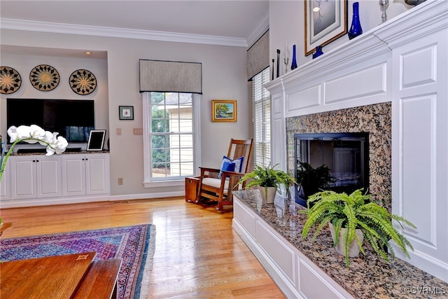 living room featuring light hardwood / wood-style floors and ornamental molding