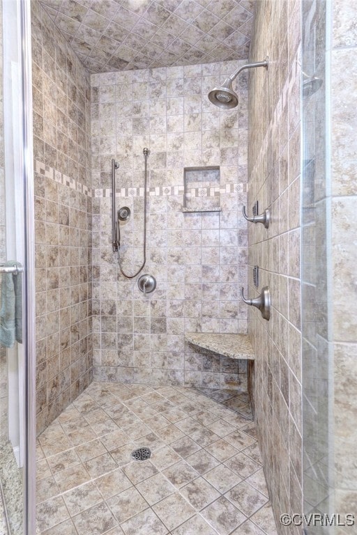 bathroom with tiled shower