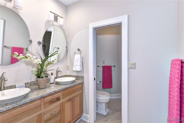 bathroom with tile patterned floors, vanity, and toilet