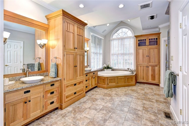 bathroom with a bathing tub, vanity, crown molding, and vaulted ceiling