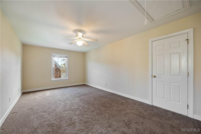 carpeted spare room featuring ceiling fan