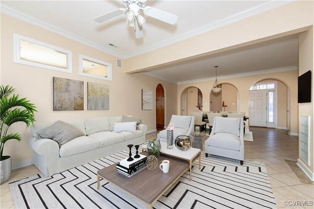 living room featuring ceiling fan, ornamental molding, and light tile patterned flooring