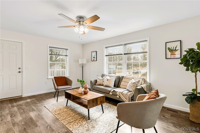 living room with wood-type flooring, a wealth of natural light, and ceiling fan