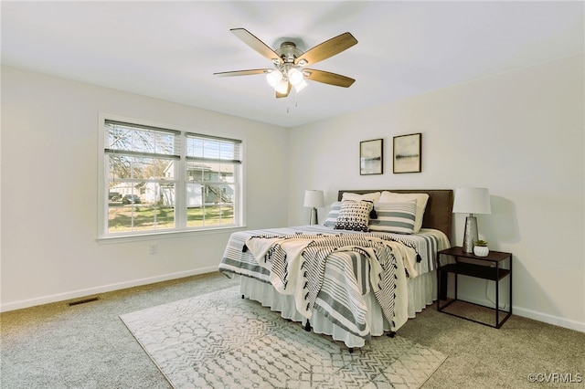 bedroom featuring ceiling fan and light carpet